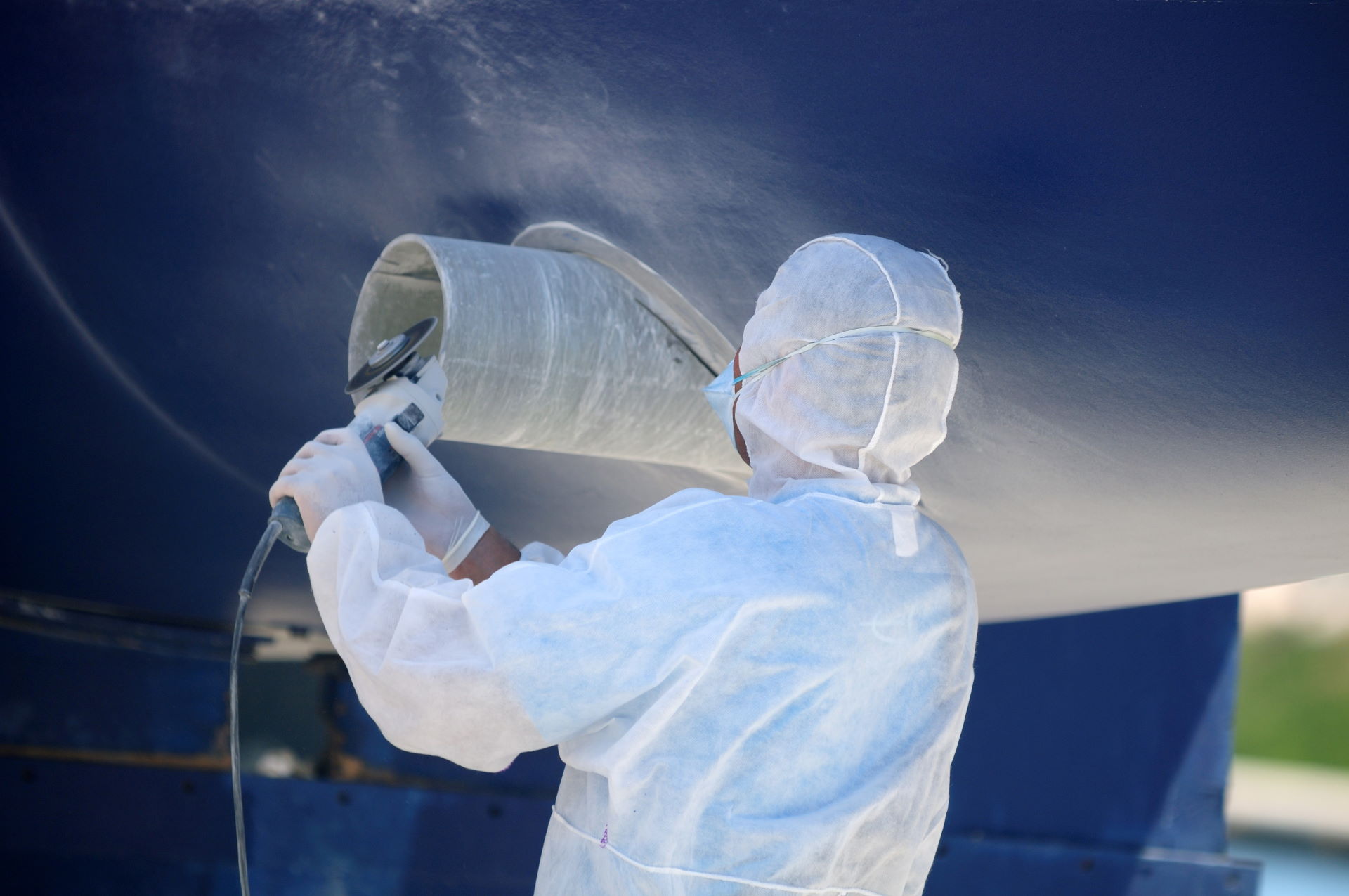 Maintenance of a yacht, maintenance is carried out by a man with a flex 