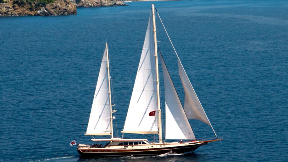 Daima yacht underway in a wind-free weather
