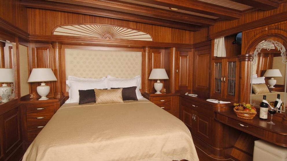 Luxurious wooden-style goulet bedroom with a large beige bed
