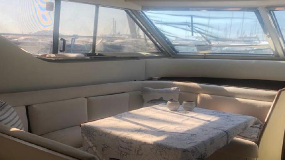 A table for eating and a sofa on a motor yacht