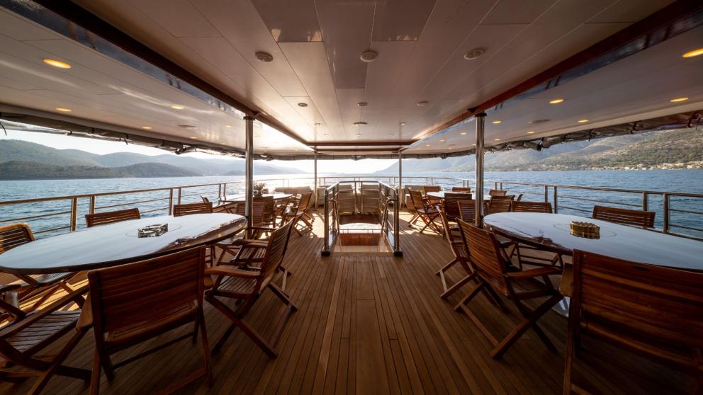 Deck dining and seating areas of luxury motor yacht Olimp