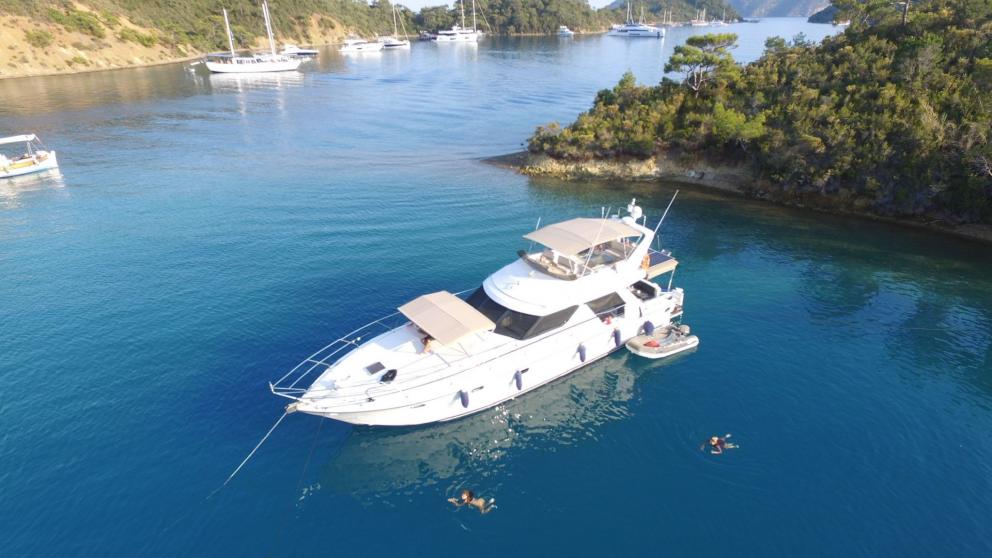 Luxury yacht Ayşe Sultan 1 in a bay in the azure sea