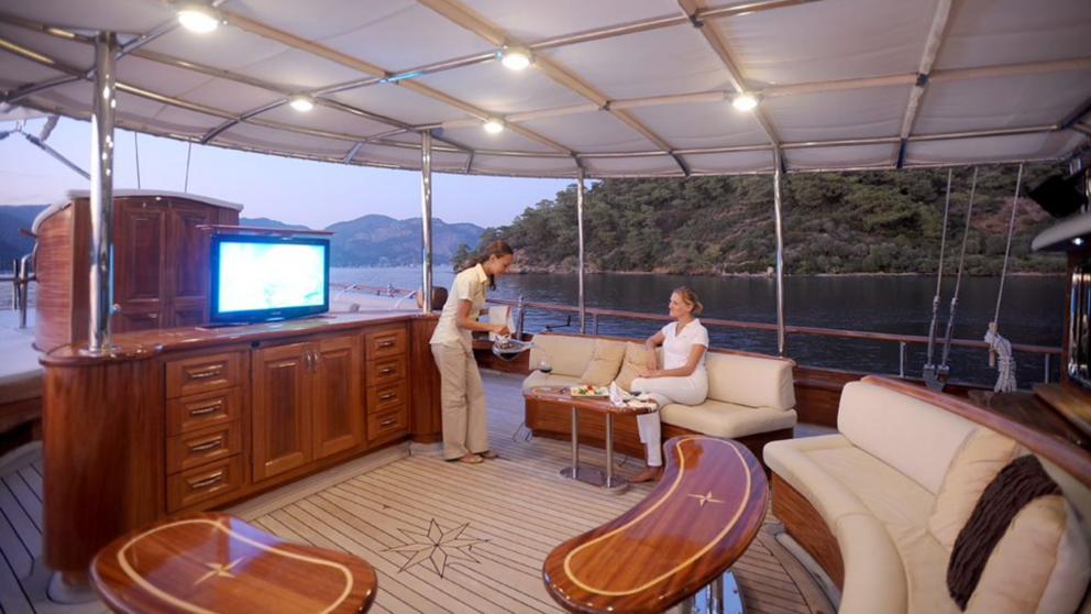 Outdoor lounge area on the upper deck of Mare Nostrum Gulet. You can watch TV and have a drink