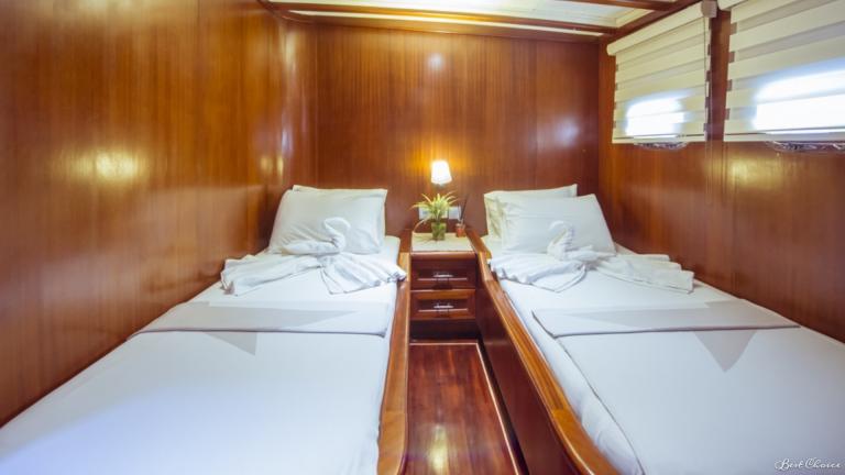 Double cabin with two single beds decorated with towel swans