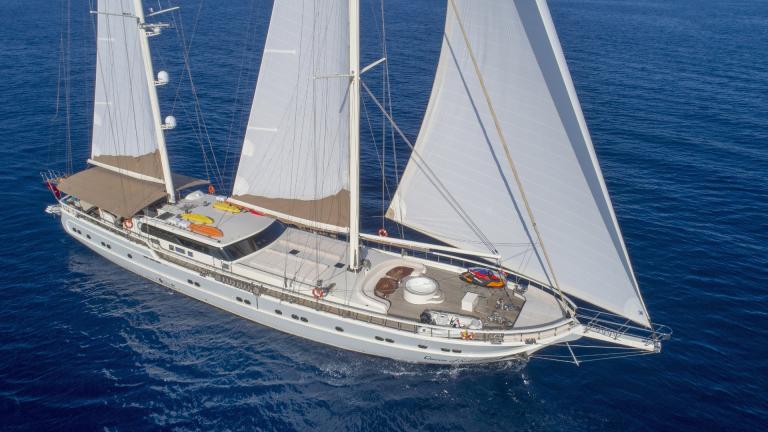 The Queen of Salmakis luxury gulet with raised sails on the open sea, weather is good