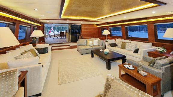 Spacious living room on the gulet. Pictured are comfortable sofas, tables, and lamps